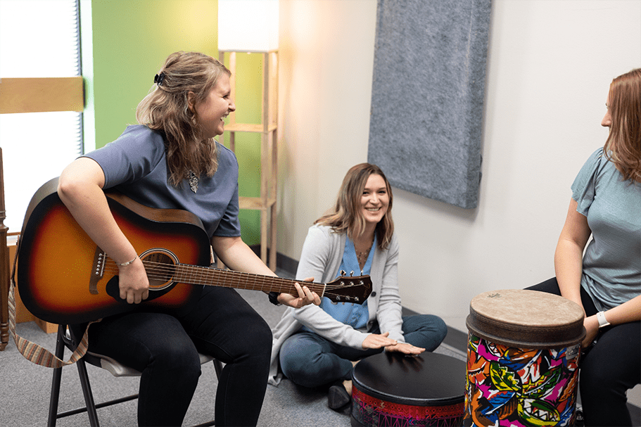 group of beautiful women smiling and playing musical instruments